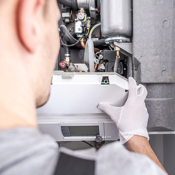 Contractor Repairing Central Heating Furnace System.